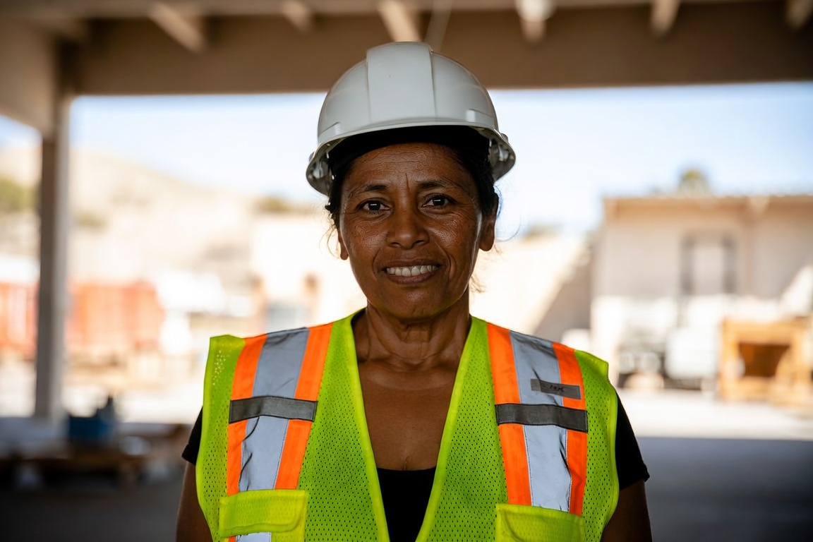 California warehouse worker in a hi-vis vest in a bright distribution center